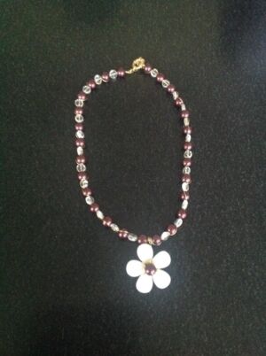 Necklace Necklace with brown pears and clear crystal beads. The flower is made with shell pearl petals. Please specify length when placing an order. Subject to availability, price on application.
