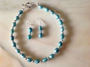Necklace and earring set Aquamarine coloured pearls and silver beads. Necklace and earring set. Can be made with pearls in other colours subject to availability. Price on application.