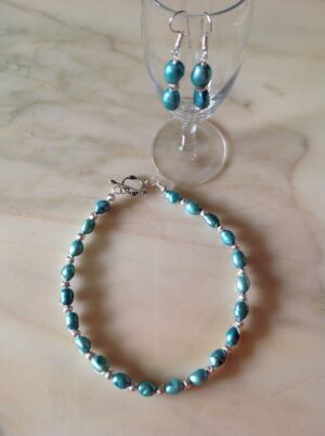 Necklace and earring set Aquamarine coloured pearls and silver beads. Necklace and earring set. Can be made with pearls in other colours subject to availability. Price on application.
