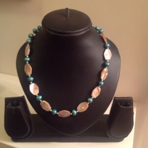 Necklace with shell pearls Necklace with shell pearls and aquamarine coloured pearls. Price on application.