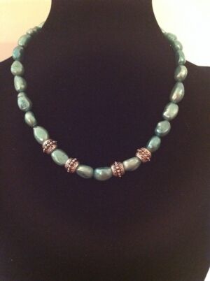 This is the Lakme series necklace using freshwater pearls. This is the Lakme series necklace using freshwater pearls. These are beautiful teal coloured pearls with silver accents and would be a lovely addition to your LBD for any formal or informal occasion.