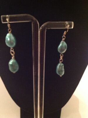 This is the Lakme series earrings using freshwater pearls. This is the Lakme series earrings using freshwater pearls. These are beautiful teal coloured pearls with silver accents and would be a lovely addition to your LBD for any formal or informal occasion.